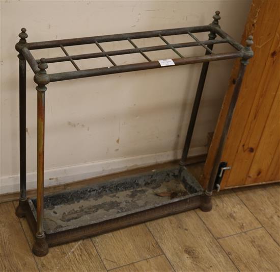 A twelve section brass and iron stick stand W.64cm